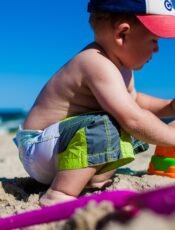 Boy playing with sand at Beach.